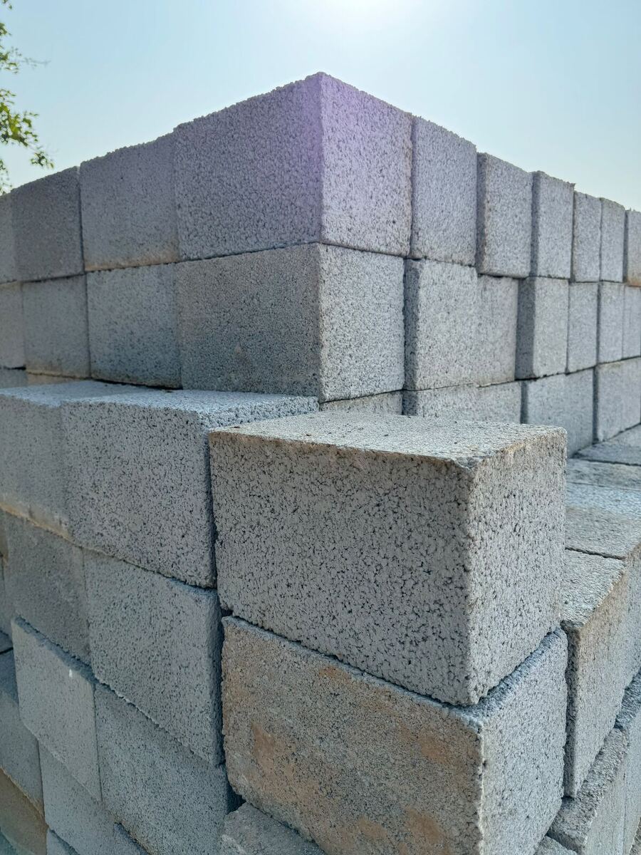Close view of stacked solid concrete blocks showing the aggregate texture of the cut face